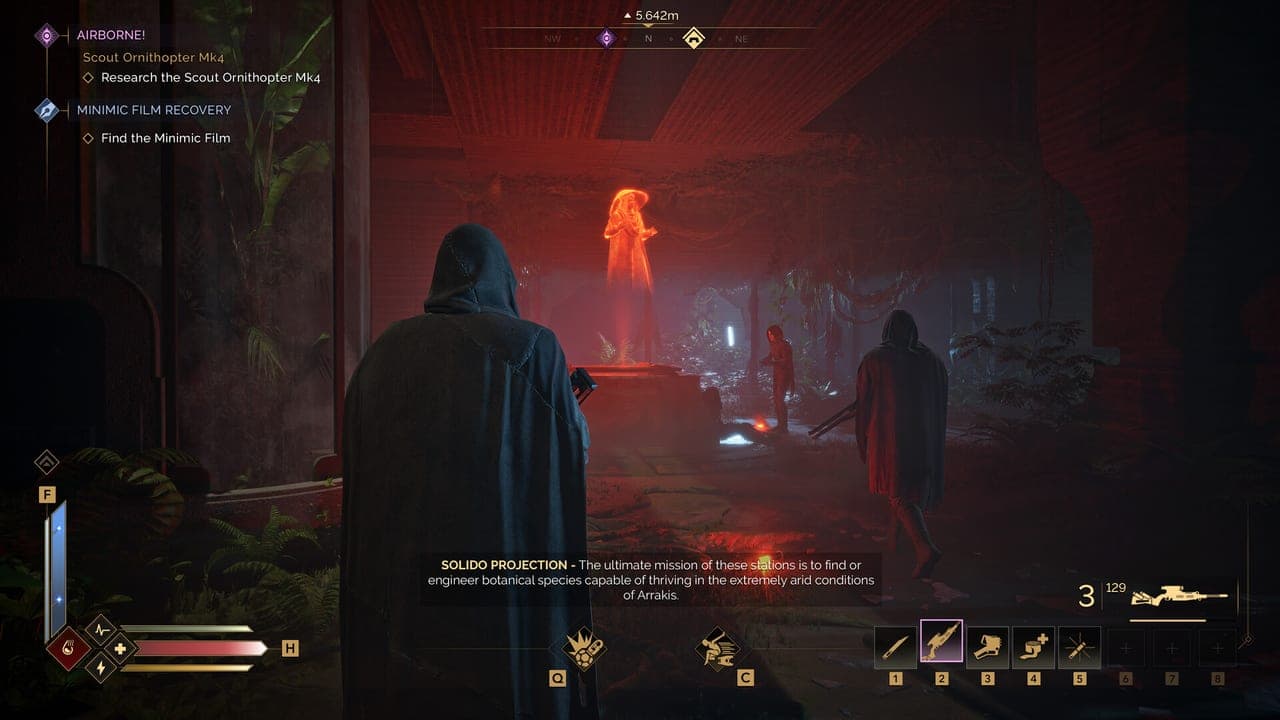 A cloaked figure watches a red hologram briefing inside a dark chamber in Dune: Awakening