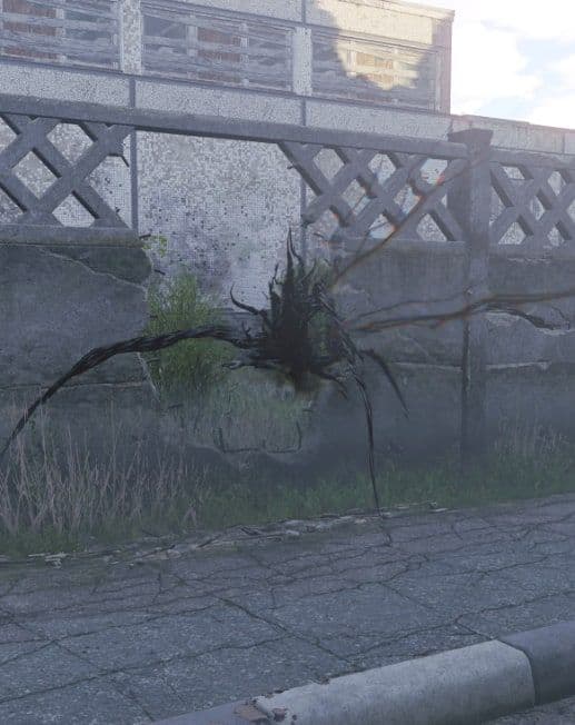 A Mimic, a spray of black tendrils, clinging to a concrete wall beside a road