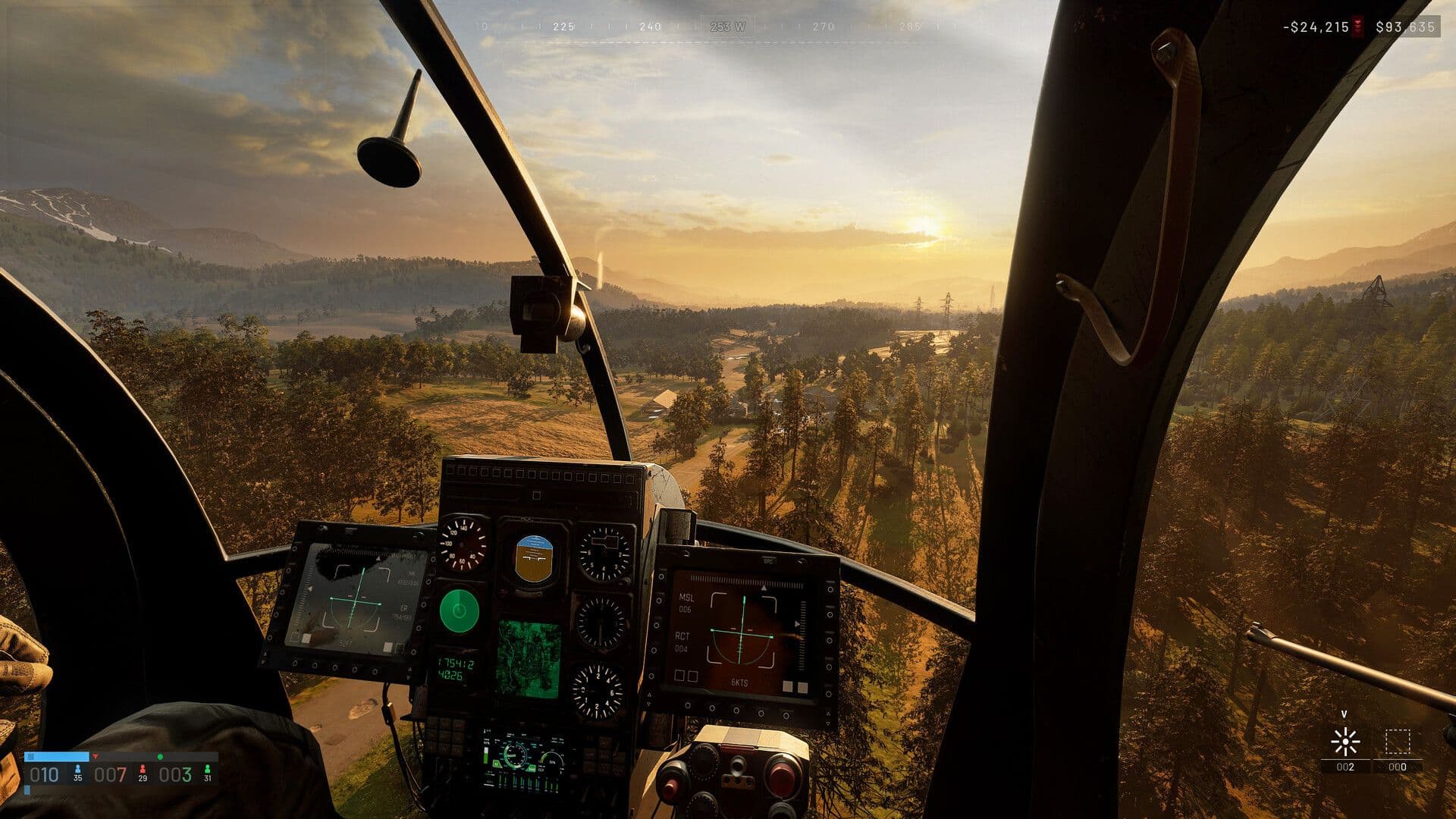 Cockpit view from a helicopter flying low over forest at sunset