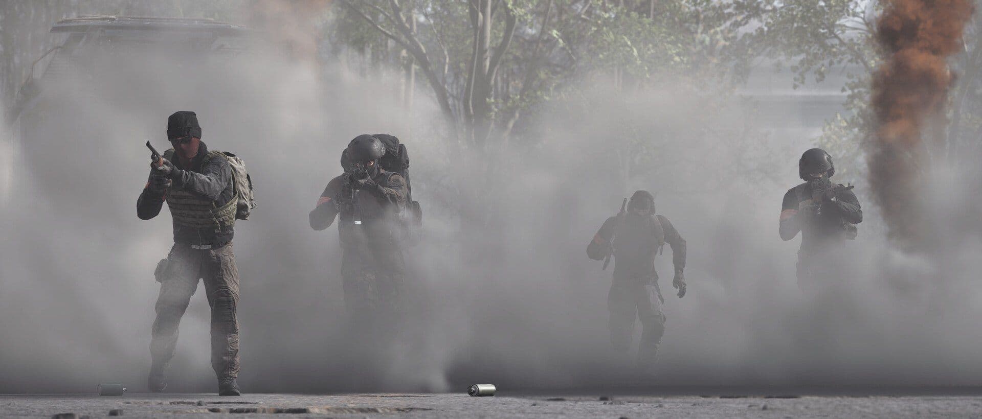 Four WARDOGS soldiers advance out of a thick smoke screen with weapons raised