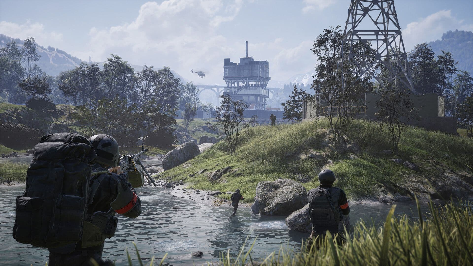 A squad with heavy packs wades a river towards a tower base