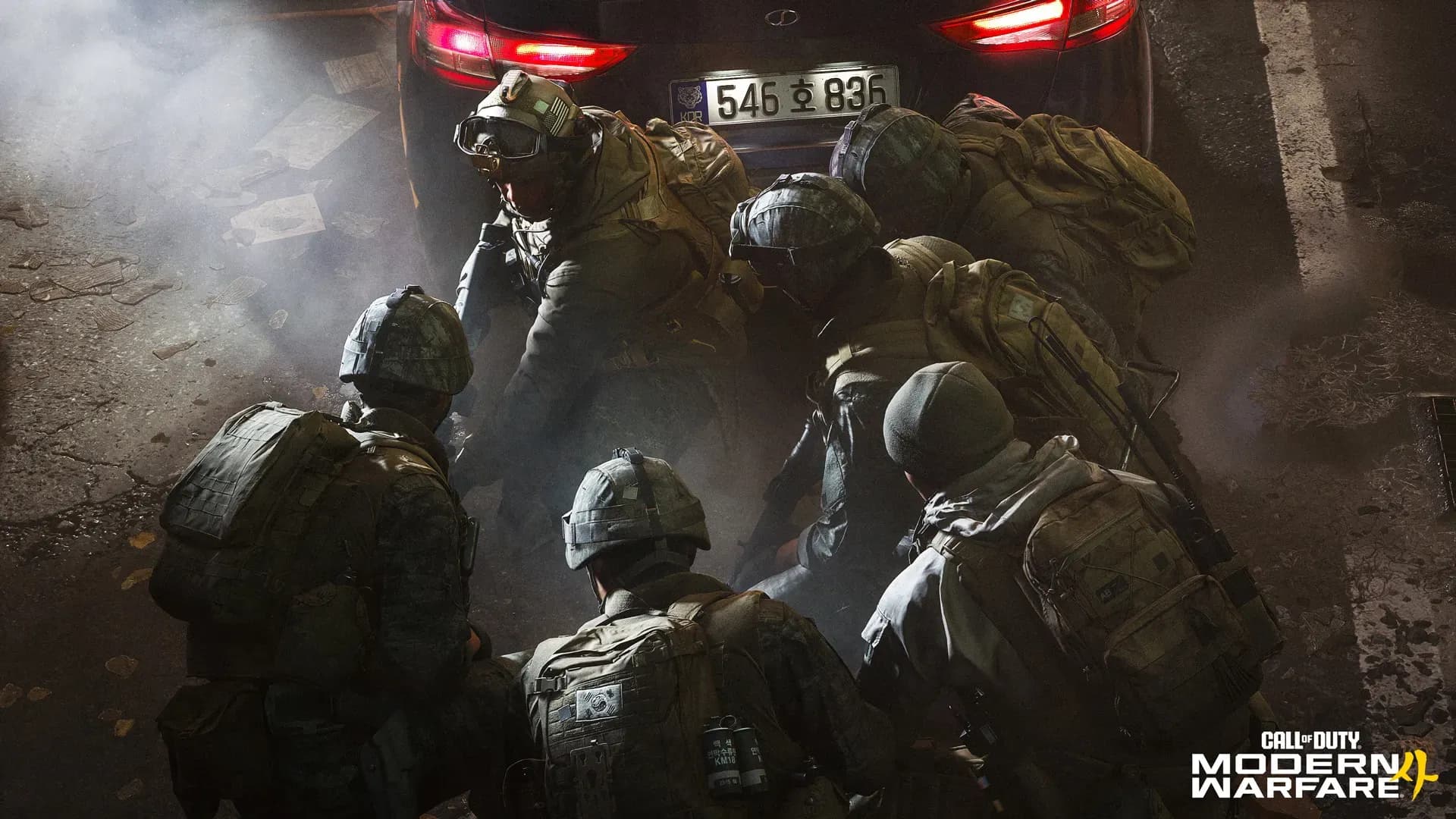 A squad of soldiers in helmets and night gear stacked up in a dark street