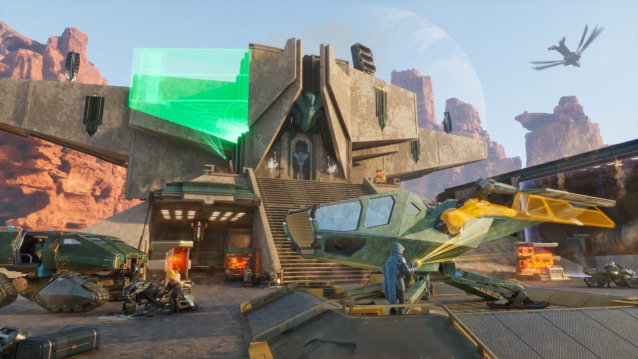 A desert base with a green holographic sign and parked vehicles in Dune: Awakening