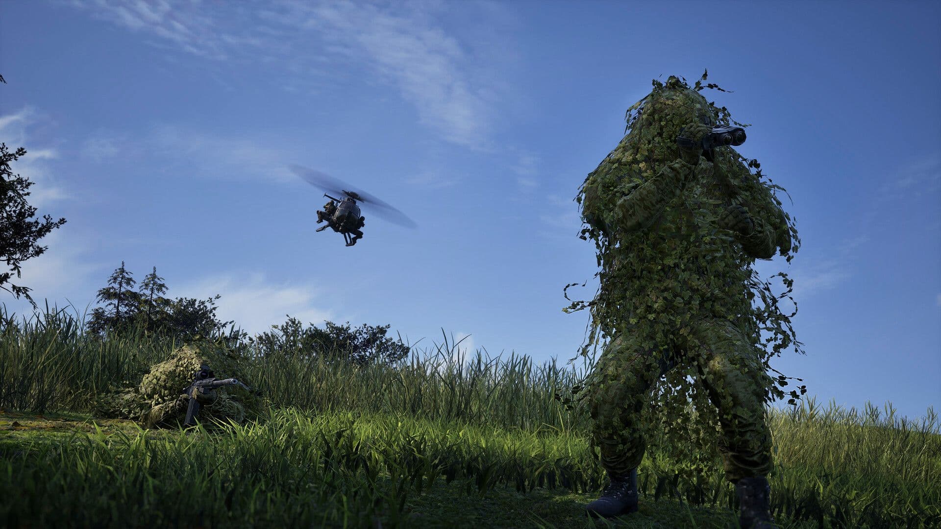 A Recon player in a ghillie suit stands in tall grass as a helicopter flies overhead